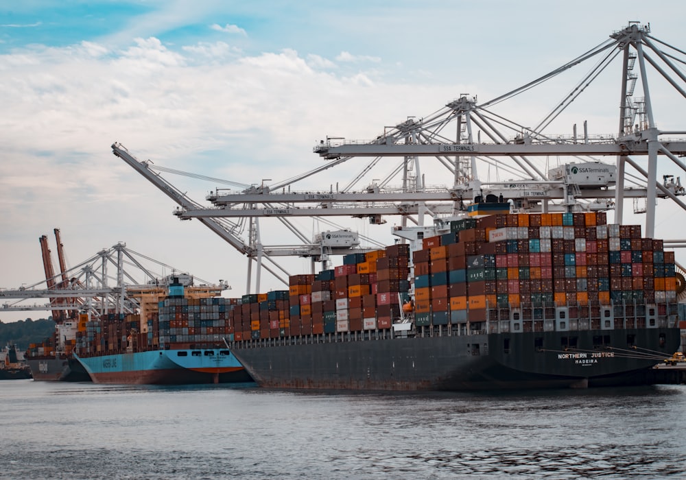 A container ship being loaded at a freight terminal.