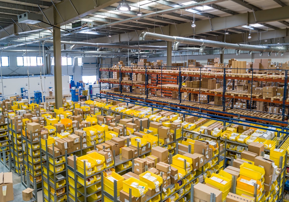 Wide view of a fulfilment warehouse with stocked yellow pallet racking.